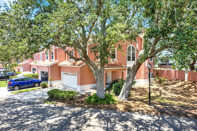 14561 El Paseo Dr, Seminole, FL 33776 - townhome / multi-family property featuring driveway, a garage, and stucco siding
