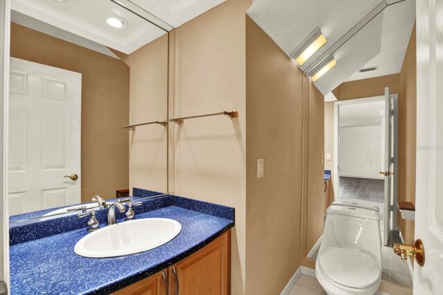 14561 El Paseo Dr, Seminole, FL 33776 - bathroom featuring vanity, toilet, and baseboards