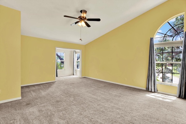 14561 El Paseo Dr, Seminole, FL 33776 - carpeted spare room with a ceiling fan, vaulted ceiling, and baseboards