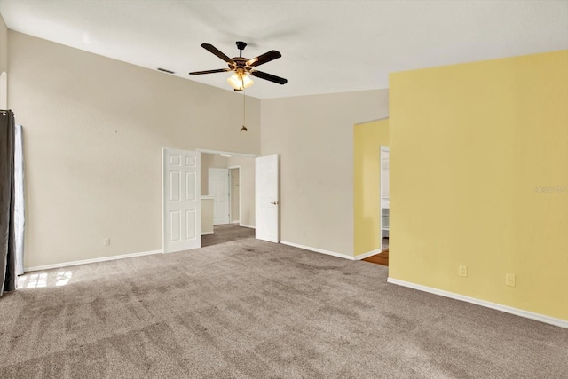 14561 El Paseo Dr, Seminole, FL 33776 - carpeted empty room featuring ceiling fan, vaulted ceiling, and baseboards