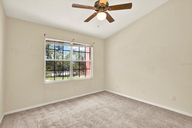 14561 El Paseo Dr, Seminole, FL 33776 - carpeted empty room featuring baseboards, a ceiling fan, and lofted ceiling