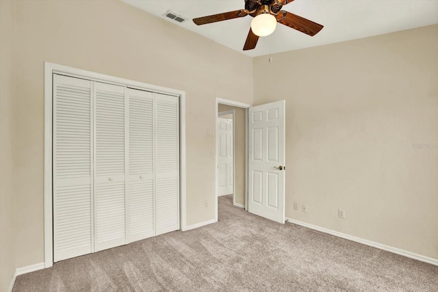 14561 El Paseo Dr, Seminole, FL 33776 - unfurnished bedroom featuring carpet floors, a closet, baseboards, lofted ceiling, and a ceiling fan