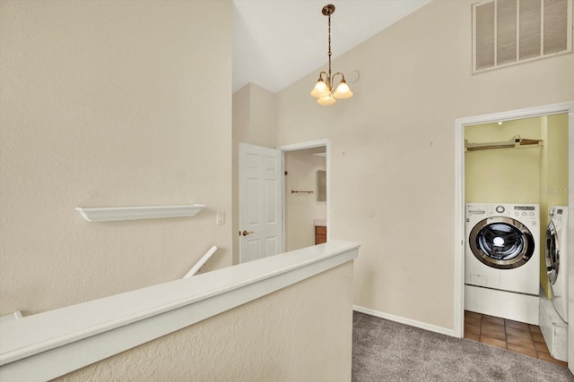 14561 El Paseo Dr, Seminole, FL 33776 - laundry area featuring independent washer and dryer, a chandelier, dark carpet, a high ceiling, and baseboards