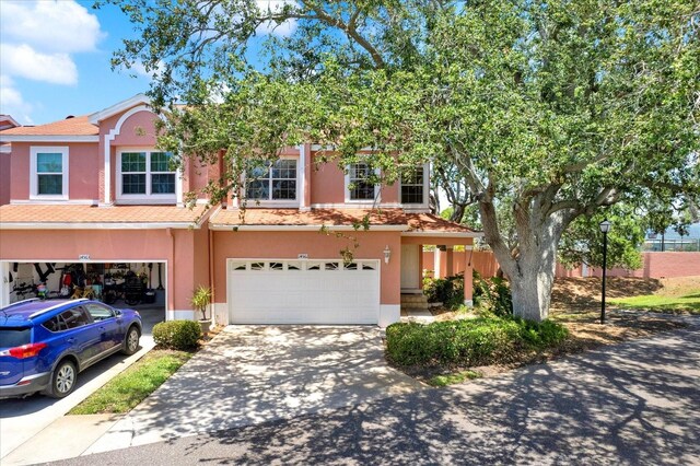 14561 El Paseo Dr, Seminole, FL 33776 - multi unit property featuring stucco siding, driveway, and a garage
