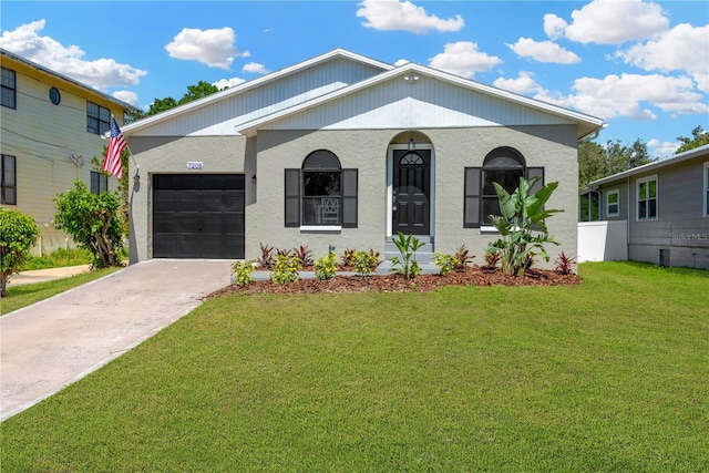 7208 S Juanita St, Tampa, FL 33616 - view of front of home featuring an attached garage, a front yard, and concrete driveway