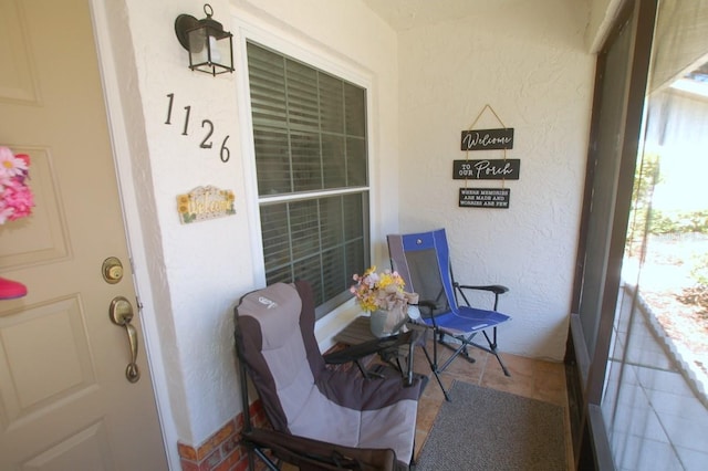 1126 Tarridon Ct, Dunedin, FL 34698 - view of exterior entry featuring a porch and stucco siding