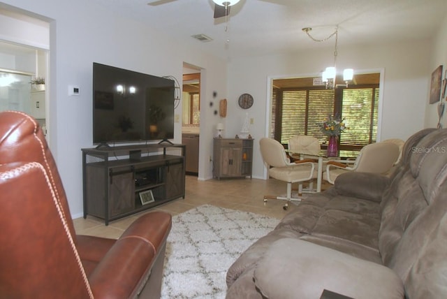 1126 Tarridon Ct, Dunedin, FL 34698 - living room with a chandelier, light tile patterned floors, ceiling fan, and baseboards