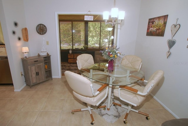 1126 Tarridon Ct, Dunedin, FL 34698 - dining space featuring a chandelier, light tile patterned floors, and baseboards