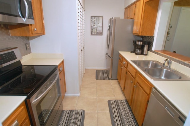 1126 Tarridon Ct, Dunedin, FL 34698 - kitchen with stainless steel appliances, a sink, brown cabinets, tasteful backsplash, and light countertops