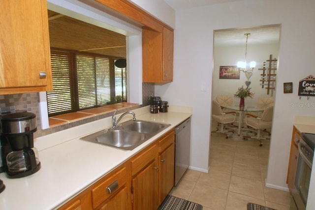 1126 Tarridon Ct, Dunedin, FL 34698 - kitchen with a sink, dishwasher, light tile patterned floors, a chandelier, and brown cabinets