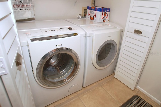 1126 Tarridon Ct, Dunedin, FL 34698 - laundry area featuring washer and clothes dryer and light tile patterned floors