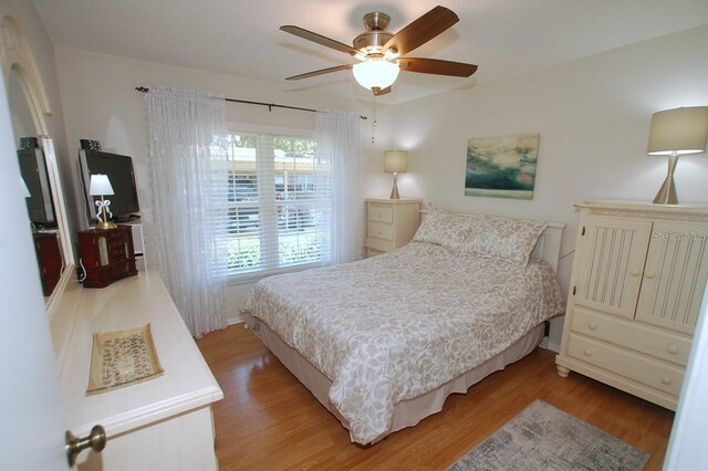 1126 Tarridon Ct, Dunedin, FL 34698 - bedroom with light wood-type flooring, baseboards, and ceiling fan