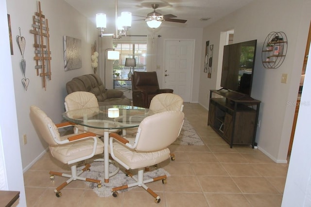 1126 Tarridon Ct, Dunedin, FL 34698 - dining space featuring light tile patterned flooring, ceiling fan, and baseboards
