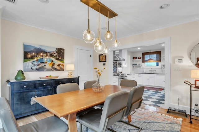 221 13th Ave NE, Saint Petersburg, FL 33701 - dining area with light wood-type flooring, crown molding, and recessed lighting