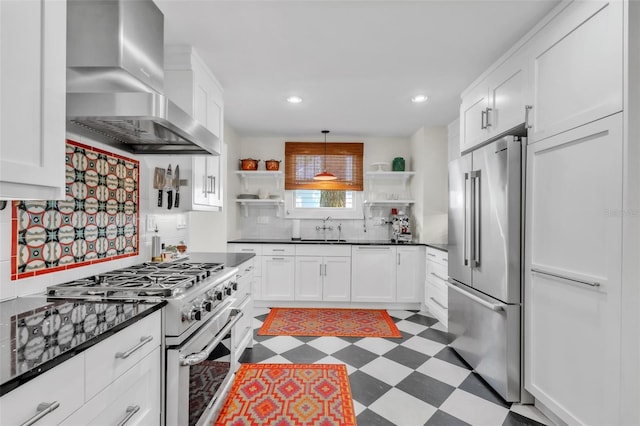 221 13th Ave NE, Saint Petersburg, FL 33701 - kitchen with high quality appliances, open shelves, wall chimney exhaust hood, a sink, and dark countertops