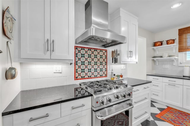 221 13th Ave NE, Saint Petersburg, FL 33701 - kitchen with stainless steel range, wall chimney exhaust hood, open shelves, backsplash, and white cabinetry