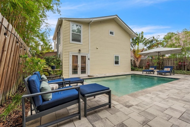 221 13th Ave NE, Saint Petersburg, FL 33701 - back of property featuring french doors, a patio, and a fenced backyard
