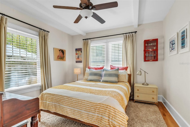 221 13th Ave NE, Saint Petersburg, FL 33701 - bedroom featuring multiple windows, wood finished floors, beamed ceiling, baseboards, and a ceiling fan
