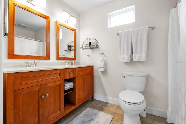 221 13th Ave NE, Saint Petersburg, FL 33701 - full bath with baseboards, double vanity, and toilet