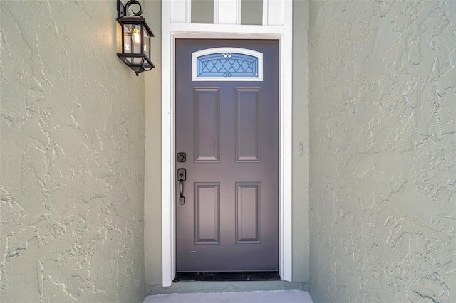 2078 Madrid Ct N, Clearwater, FL 33763 - doorway to property featuring stucco siding