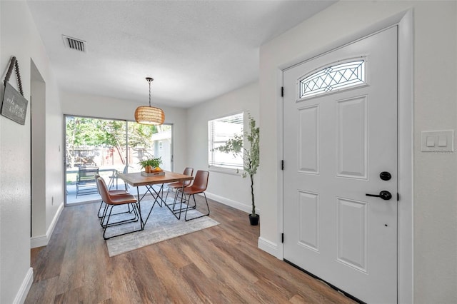 2078 Madrid Ct N, Clearwater, FL 33763 - entryway featuring baseboards, wood finished floors, and plenty of natural light