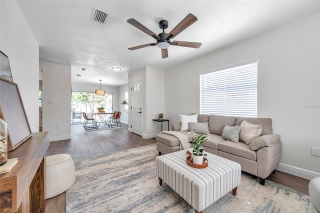 2078 Madrid Ct N, Clearwater, FL 33763 - living area with wood finished floors, baseboards, and a ceiling fan