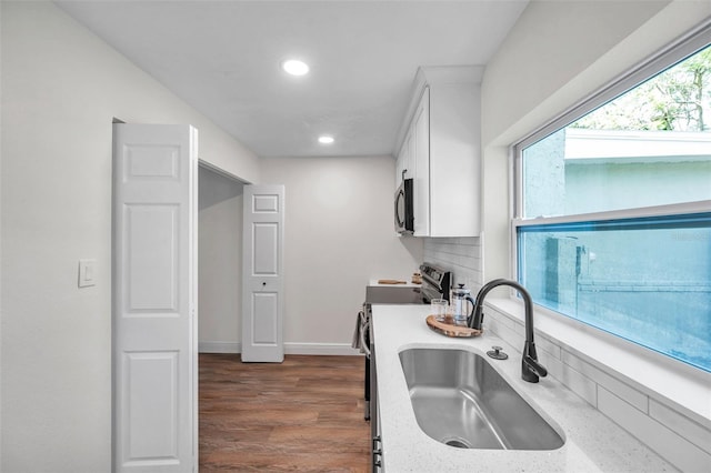 2078 Madrid Ct N, Clearwater, FL 33763 - kitchen with a sink, stainless steel range with electric stovetop, white cabinets, recessed lighting, and dark wood-style flooring