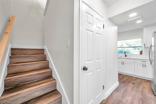 2078 Madrid Ct N, Clearwater, FL 33763 - stairs featuring wood finished floors, recessed lighting, and baseboards