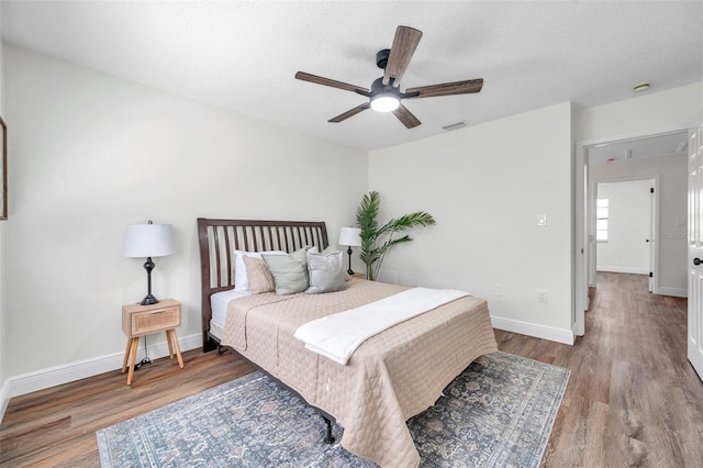 2078 Madrid Ct N, Clearwater, FL 33763 - bedroom with wood finished floors, baseboards, ceiling fan, and a textured ceiling