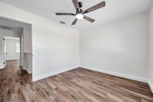 2078 Madrid Ct N, Clearwater, FL 33763 - empty room with a ceiling fan, wood finished floors, and baseboards