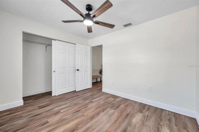2078 Madrid Ct N, Clearwater, FL 33763 - unfurnished bedroom featuring wood finished floors, baseboards, and a closet