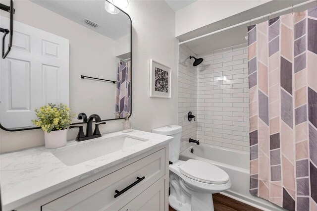 2078 Madrid Ct N, Clearwater, FL 33763 - full bath with toilet, vanity, shower / tub combo, and wood finished floors