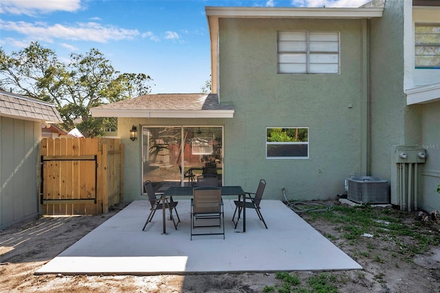 2078 Madrid Ct N, Clearwater, FL 33763 - view of patio with central air condition unit, outdoor dining space, a gate, and fence