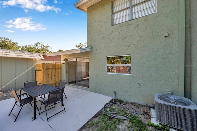 2078 Madrid Ct N, Clearwater, FL 33763 - view of patio / terrace with cooling unit, fence, and outdoor dining space