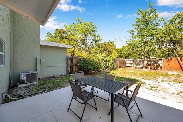 2078 Madrid Ct N, Clearwater, FL 33763 - view of patio / terrace with outdoor dining area, a fenced backyard, and cooling unit