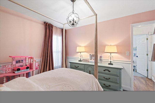 1914 Elk Spring Dr, Brandon, FL 33511 - bedroom with wainscoting, a chandelier, and wood finished floors