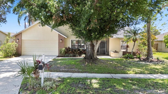 1914 Elk Spring Dr, Brandon, FL 33511 - obstructed view of property featuring an attached garage, concrete driveway, brick siding, and stucco siding