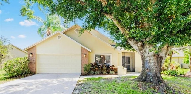 1914 Elk Spring Dr, Brandon, FL 33511 - view of front facade featuring a garage, brick siding, concrete driveway, and stucco siding