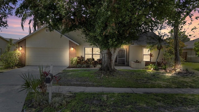 1914 Elk Spring Dr, Brandon, FL 33511 - view of front of house with driveway, an attached garage, and brick siding