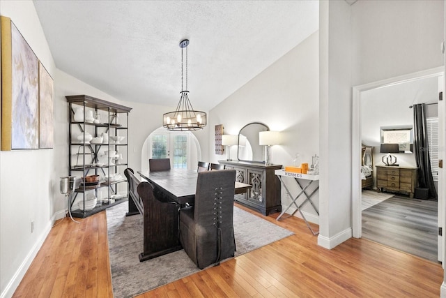 1914 Elk Spring Dr, Brandon, FL 33511 - dining space with wood finished floors, baseboards, a chandelier, a textured ceiling, and high vaulted ceiling