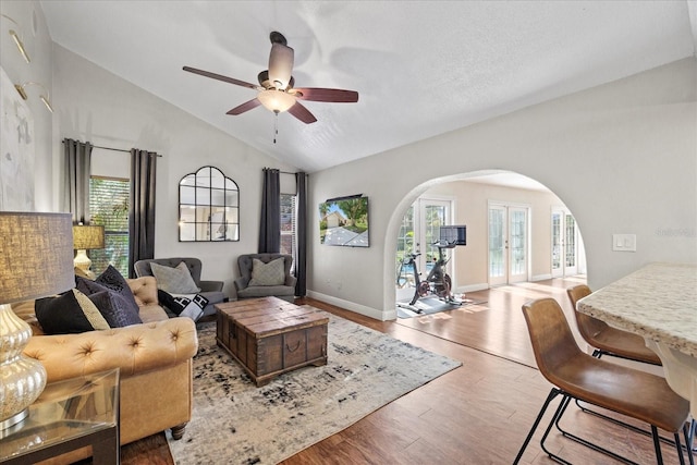 1914 Elk Spring Dr, Brandon, FL 33511 - living area with arched walkways, lofted ceiling, a ceiling fan, wood finished floors, and baseboards