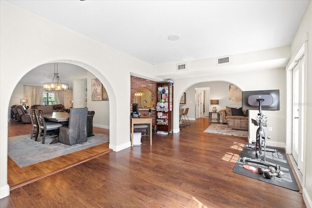 1914 Elk Spring Dr, Brandon, FL 33511 - dining space with arched walkways, wood finished floors, a chandelier, and baseboards