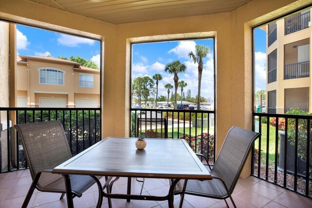 4333 Bayside Village Dr Unit 110, Tampa, FL 33615 - sunroom / solarium featuring tile patterned flooring, plenty of natural light, and wood ceiling