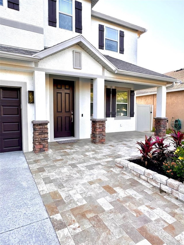 1147 Halapa Way, Trinity, FL 34655 - entrance to property with stucco siding and a porch