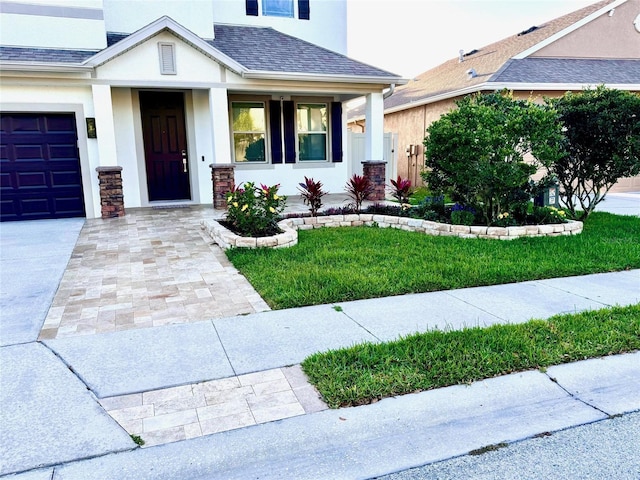 1147 Halapa Way, Trinity, FL 34655 - view of front facade featuring stucco siding, roof with shingles, driveway, and covered porch