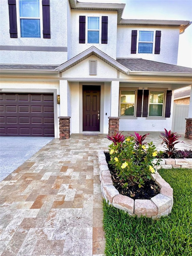 1147 Halapa Way, Trinity, FL 34655 - view of front of home with stucco siding, an attached garage, and driveway