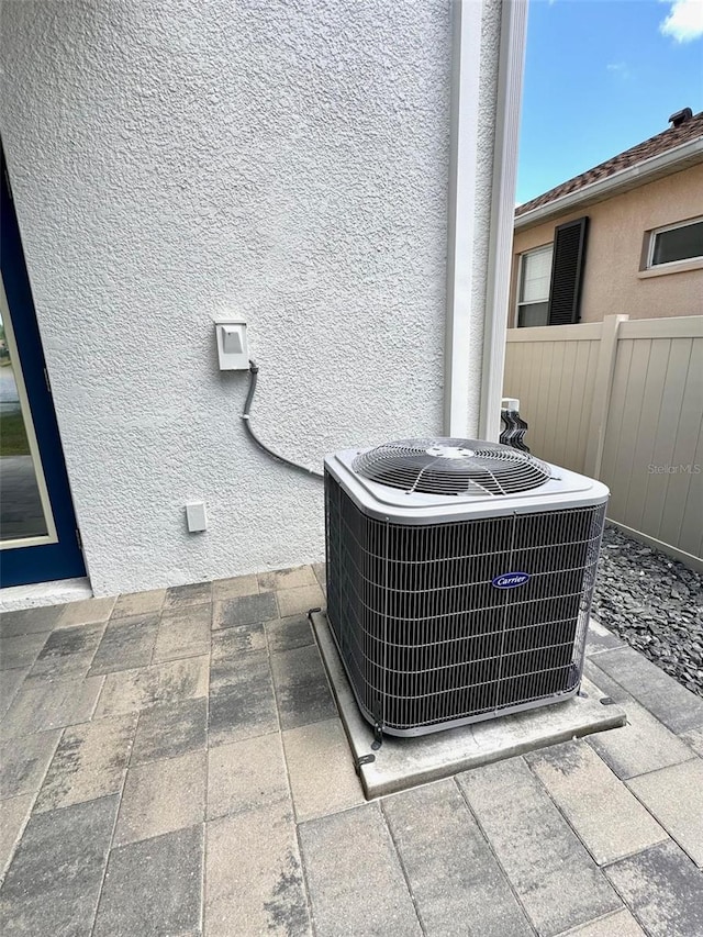 1147 Halapa Way, Trinity, FL 34655 - exterior view of central air condition unit, stucco siding, and fence