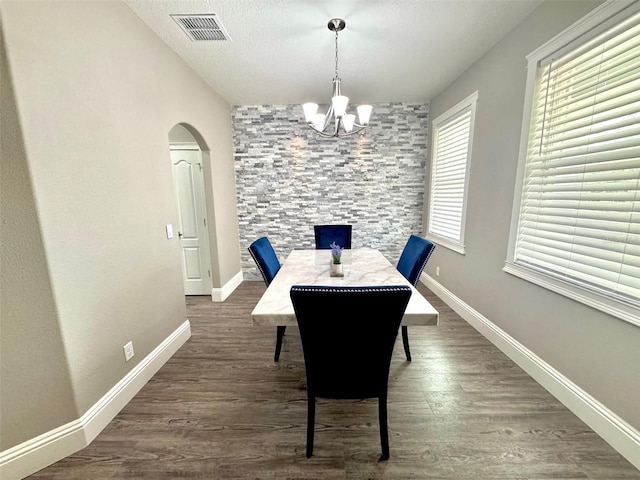 1147 Halapa Way, Trinity, FL 34655 - dining area featuring a chandelier, arched walkways, wood finished floors, and baseboards