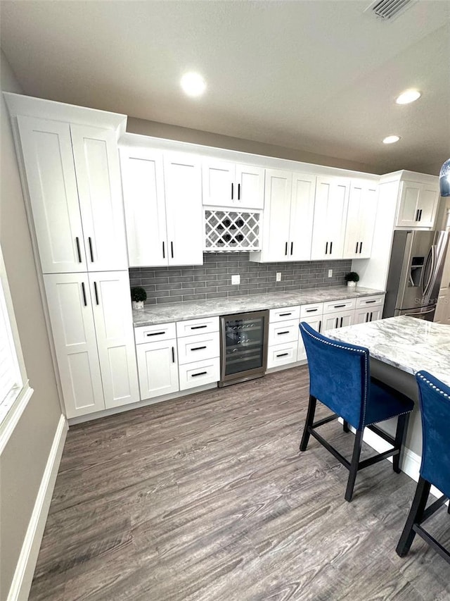 1147 Halapa Way, Trinity, FL 34655 - indoor bar featuring stainless steel fridge, wine cooler, baseboards, dark wood-type flooring, and recessed lighting
