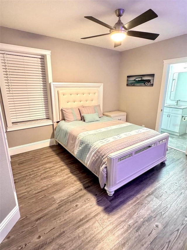 1147 Halapa Way, Trinity, FL 34655 - bedroom featuring wood finished floors, baseboards, a sink, and ensuite bath